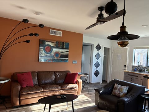 Another view of living room area, front door in background.