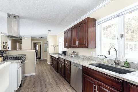 Upstairs full kitchen, stocked with coffee, dishes, cooking items. 
