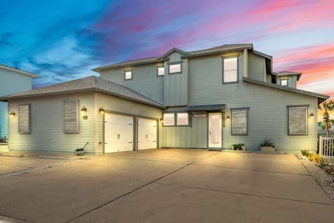Modern coastal retreat just minutes from the beach—spacious driveway and welcoming front entry.