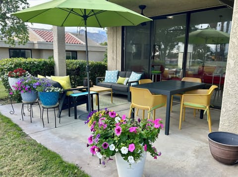 East patio has 2 love seats, dining table, umbrella & infrared heaters
