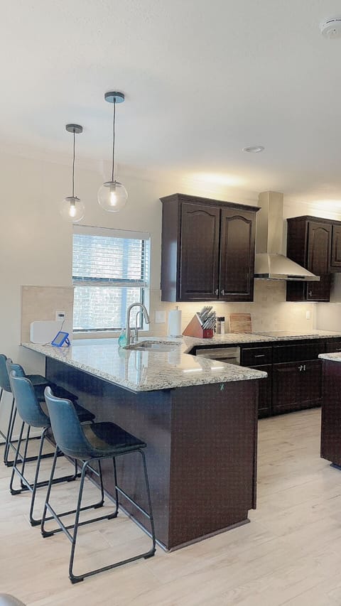 Fully stocked kitchen with bar and island.  A second fridge is located in the garage space.