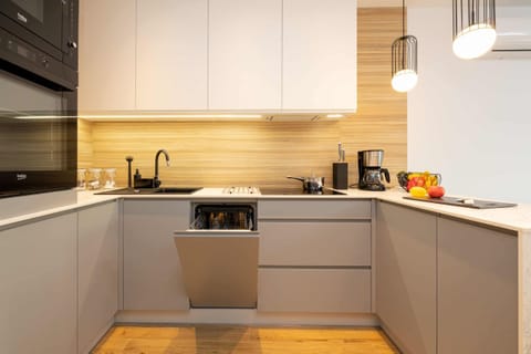 Kitchen area with high-quality appliances such as dishwasher, coffee machine and oven.