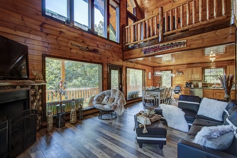 Spacious living room with oversized windows, cathedral celling and gas fireplace