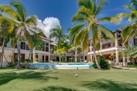 Large pool area with outdoor living, lanai with alfresco dining, next to beach.