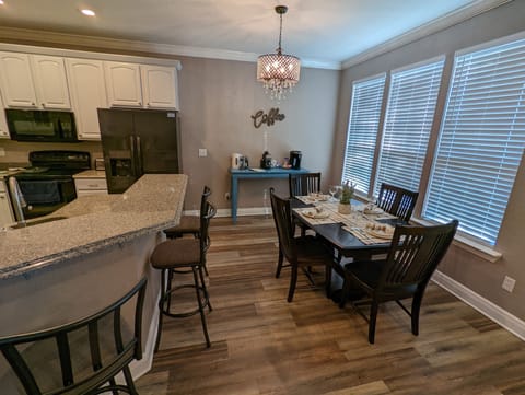 Bar seating and dining table close to breakfast coffee bar