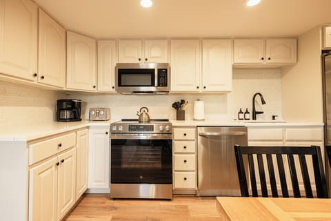 Bright and updated kitchen featuring stainless appliances and spacious countertops.