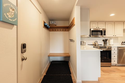 Entryway with ski hooks, bench seating, and easy access to the kitchen — perfect for gear drop-off.