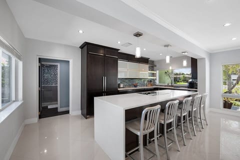 Prepare a family meal in the fully-equipped kitchen offering bar seating, updated appliances and pool views.