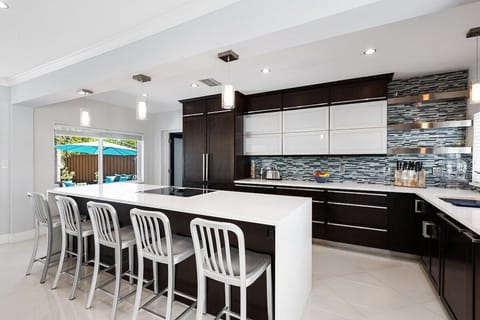 Prepare a family meal in the fully-equipped kitchen offering bar seating, updated appliances and pool views.