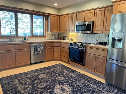 Large kitchen with new refrigerator and oven.