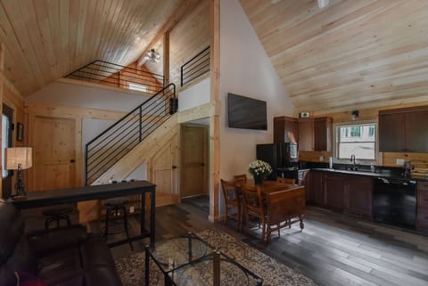 View of the kitchen as well as stairs to loft with pipe railing