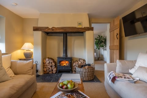 Evergreen, Thornage: Cosy sitting room with wood burning stove