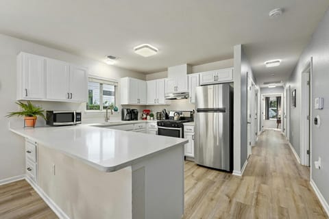 Spacious, open kitchen flows into the hallway—ideal for group stays, meal prep, and gathering after exploring East Austin.