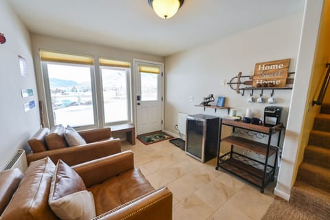 Beverage station and mini-fridge with coffee maker, mugs, and wine glasses