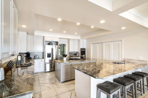 Bright, fully equipped kitchen designed for effortless group cooking and gatherings.