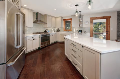 Full kitchen with stainless steel appliances.