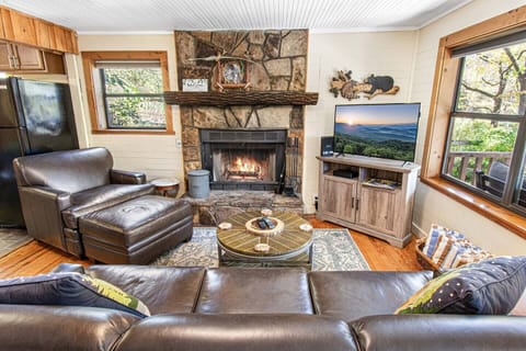 Cozy living room with wood burning fireplace, TV, high speed Wi-Fi,  and cable