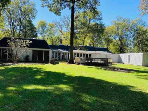Private backyard view. The patio includes a fire pit and a grill.