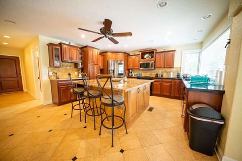 Large kitchen has plenty of light. Built-in wet bar & wine fridge. Garage access