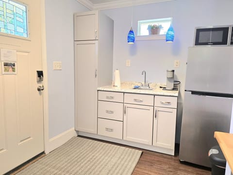 Enter through the kitchenette with a full fridge, microwave, dishes, toaster, silverware, Keurig & starter Keurig pods w/sweetener & a single burner and pans to make your morning eggs.
