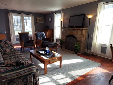 Beautiful living room featuring a limestone fireplace with new gas logs. 