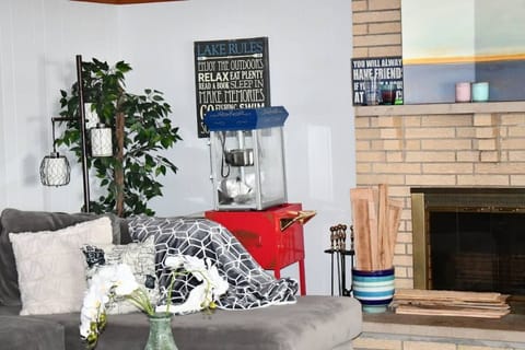 Main living room area with wood-burning fireplace & popcorn machine.