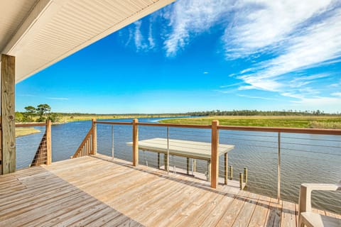 The front door of the house and deck overlooking Bayou Lacombe.