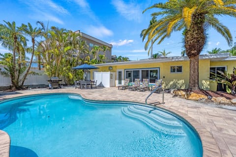 Pool and patio with dining areas, chaise lounge bank and seating.
