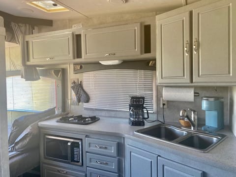 Small kitchen with double sink, fridge/freezer,  stove burner and microwave!