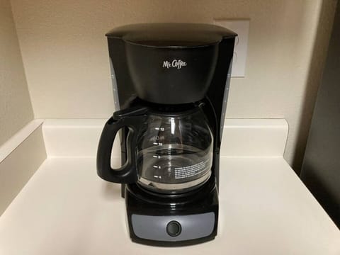 The Caffee maker and Keurig machine are in the kitchen with some essentials.