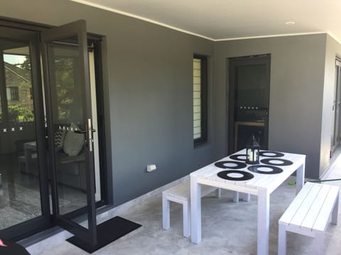 Large balcony with seating and BBQ area opening from kitchen and lounge area.
