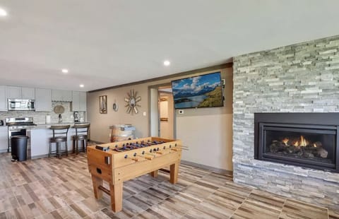 Game room includes gas fireplace and large flat screen with Hulu.