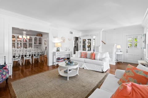 Living Room: Two sofa beds, nautical decor, historic decorative fireplace.