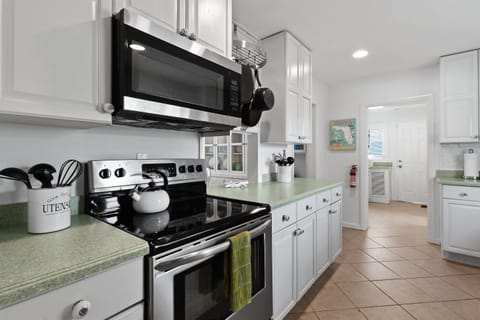Kitchen: Well-equipped with indoor and outdoor dining sets, appliances, and utensils.