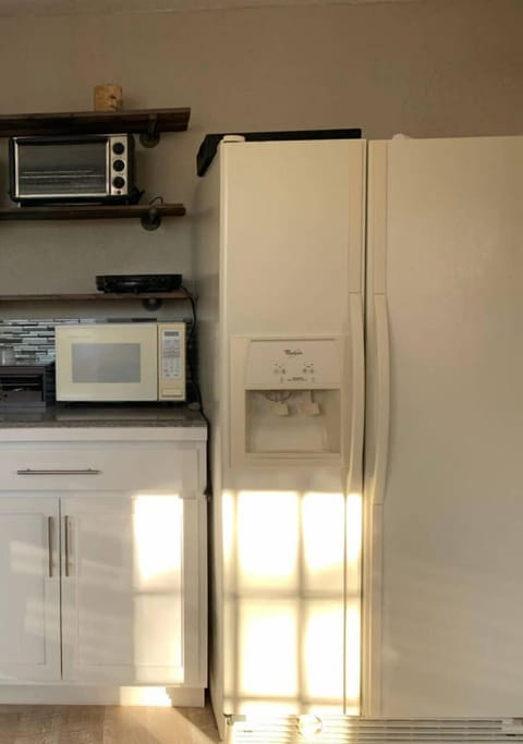 A large fridge-freezer with ice dispenser.