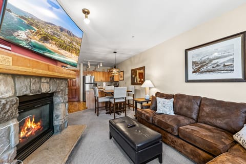 Cozy up by your crackling fireplace with mountain views on the big screen, plush leather seating, and a fully equipped kitchen nearby.