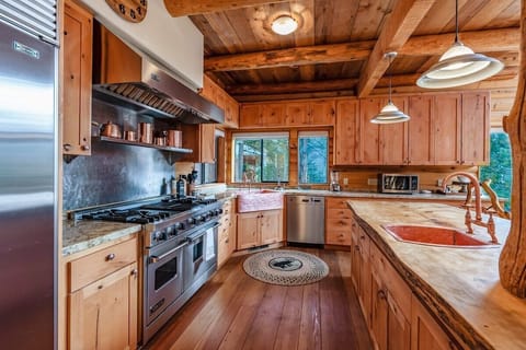 Waterfall Lodge is a tri-level masterpiece. Featuring massive logs, stone pillars, and two gorgeous waterfalls right off one of the three back decks. 