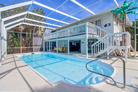 The fully screened lanai creates an enjoyable outdoor living space, with deck, heated pool, kitchen and dining.