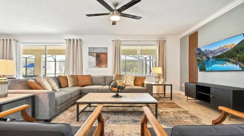 Generously sized living room featuring a cozy sofa, creating an inviting and comfortable space ideal for cherished family reunions and quality time together.
