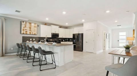 Kitchen featuring a convenient breakfast bar, offering a stylish and casual dining space.