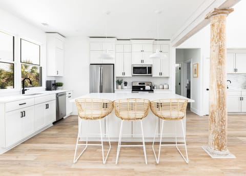 Open-Concept Kitchen with Island Seating – Fully equipped for entertaining and vacation meal prep.