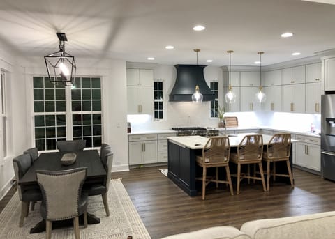 Gourmet kitchen with a double oven range with 4 burners and a griddle.