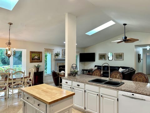 Open floor plan with spacious kitchen. Note: TV is now above the fireplace.