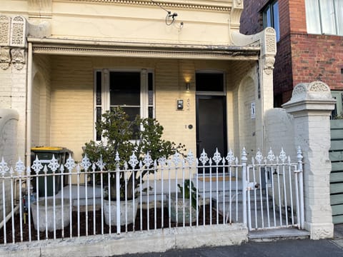 Victorian Terrace front entry with outdoor armchair to watch the neighbourhood 
