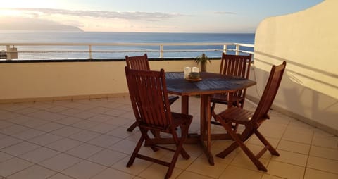 Terrace with a wooden table and chairs