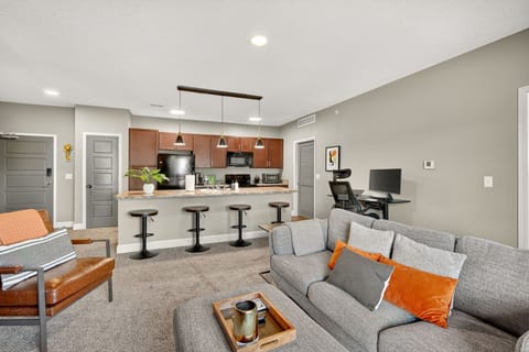 Tucked between the kitchen and the living room is a height adjustable desk along with widescreen monitor.