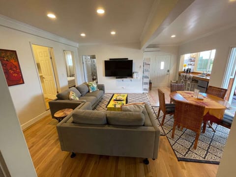 Downstairs living space sports a 65” tv, game table and coffee/wine bar