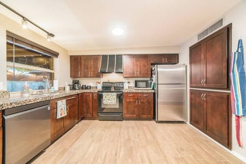 Stepping into sophistication with our rich and inviting dark wood-themed kitchen