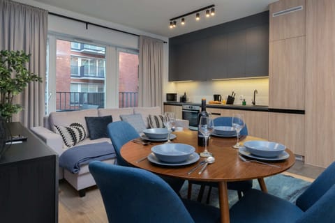 The spacious living room features a comfortable sofa bed and a flat-screen television.