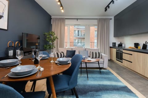 The living room's elegant decor is complemented by functional kitchenette.